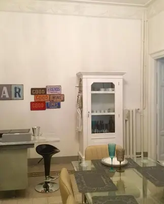 a living room with a glass table and chairs at A casa di Fiamma in Rome