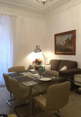 a living room with a table and a couch at A casa di Fiamma in Rome