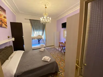 a bedroom with a bed and a chandelier at Sweet Sleep Vatican in Rome