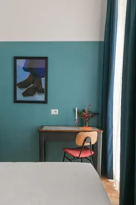 a bedroom with a desk and a table with a chair at Passepartout in Rome