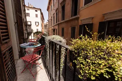 a balcony with a table and a chair on a balcony at Passepartout in Rome