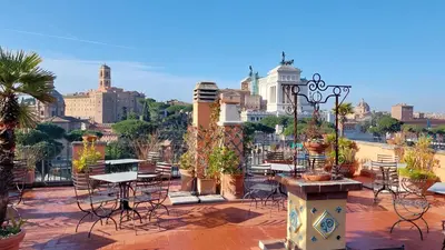 a patio with tables and chairs with a view of a city at Residenza Maritti Decò Style- Guesthouse in Rome