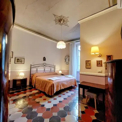 a bedroom with a bed and a checkered floor at Residenza Maritti Decò Style- Guesthouse in Rome