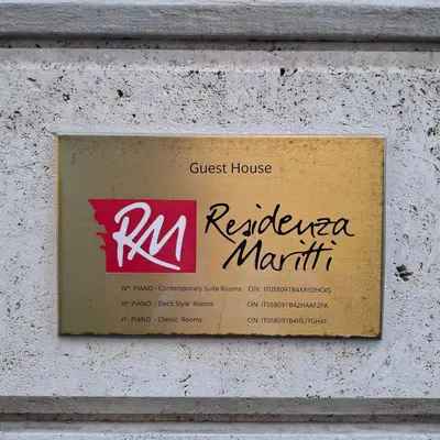 a sign on a wall with a guest house reederma marriott at Residenza Maritti Classic Rooms - Guesthouse in Rome