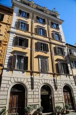 a tall yellow building with windows and doors at Residenza Maritti Classic Rooms - Guesthouse in Rome