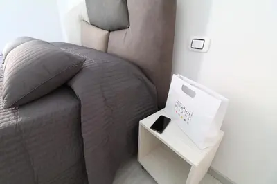 a bedroom with a bed with a night stand next to it at CinqueSogni Guest House in Rome