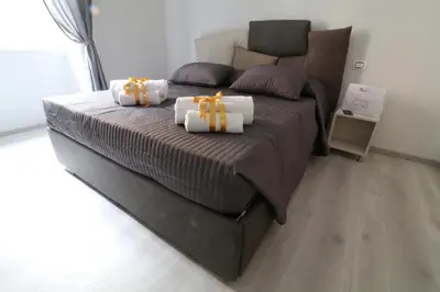 a bedroom with a bed with two towels on it at CinqueSogni Guest House in Rome