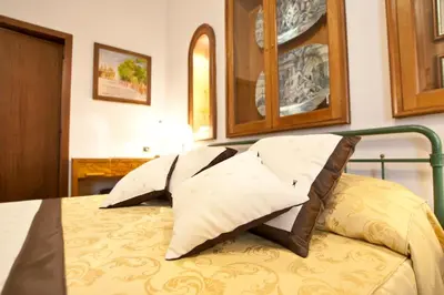 a bed with two pillows on top of it at Guesthouse Borromeo Roma in Rome