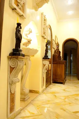 a room with a wall with sculptures on the walls at Guesthouse Borromeo Roma in Rome