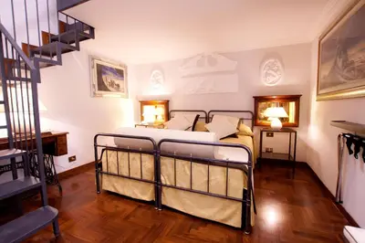 a bedroom with a bed and a staircase at Guesthouse Borromeo Roma in Rome