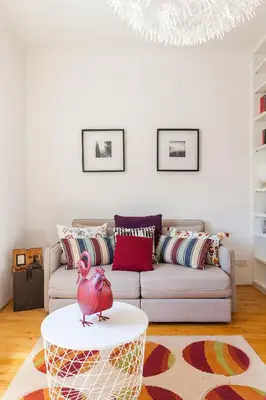 a living room with a couch and a pink bird on a coffee table at Il Nascondiglio del Prete in Rome