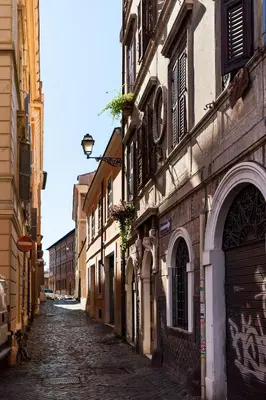 an empty street in a city with buildings at Il Nascondiglio del Prete in Rome