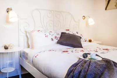 a bedroom with a white bed with flowers on it at Il Pesco Al Vaticano in Rome