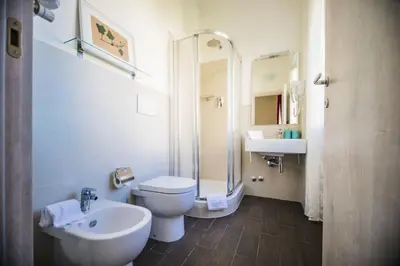 a bathroom with a toilet and a sink and a shower at Il Pesco Al Vaticano in Rome