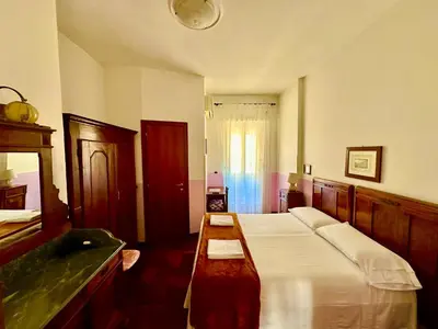a bedroom with two beds and a sink at Pardis Guest house in Rome