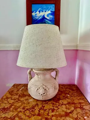a white vase with a lamp on a table at Pardis Guest house in Rome