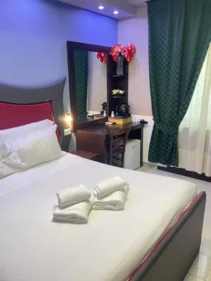 a bedroom with a bed with a desk and a mirror at Gold House in Rome