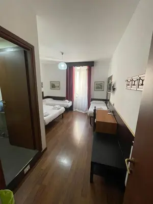 a hospital room with two beds and a mirror at Gold House in Rome