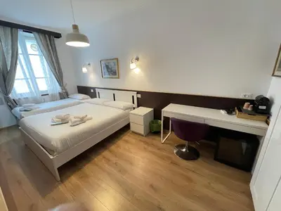 a hotel room with a bed and a desk and a desk at Gold House in Rome