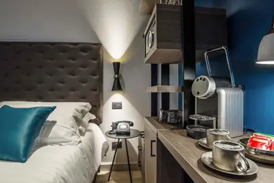 a bedroom with a large bed and a desk with a bed sidx sidx at Navona Street Hotel in Rome