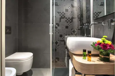 a bathroom with a white toilet and a sink at Navona Street Hotel in Rome