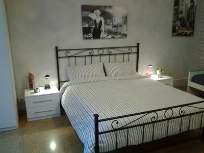 a bedroom with a large bed and two night stands at Long Bridge House in Rome