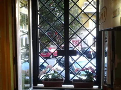 a window with two potted plants on a window sill at Long Bridge House in Rome