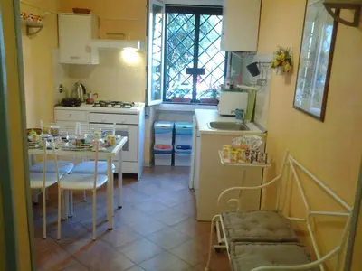 a small kitchen with a table and a sink at Long Bridge House in Rome