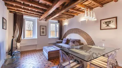 a living room with a table and a couch at Rental in Rome - Scala Suite in Rome