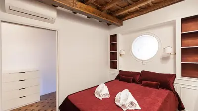 a bedroom with a red bed and a window at Rental in Rome - Scala Suite in Rome