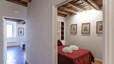 a bedroom with a red table in a room at Rental in Rome - Scala Suite in Rome