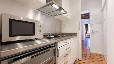 a kitchen with a sink and a microwave at Rental in Rome - Scala Suite in Rome