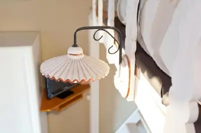 a lamp hanging on a wall next to a window at Brancaleone86 - The Loft in Rome