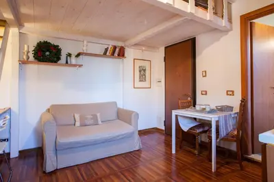 a living room with a chair and a table at Brancaleone86 - The Loft in Rome