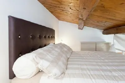 a bedroom with a large bed with a black headboard at Brancaleone86 - The Loft in Rome