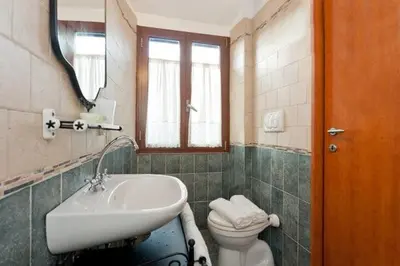 a bathroom with a sink and a toilet and a mirror at Brancaleone86 - The Loft in Rome