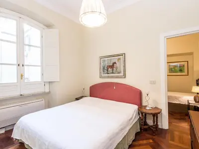 a white bedroom with a large bed and a window at Apartment Silla by Interhome in Rome