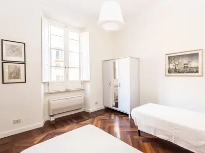 a white room with two beds and a mirror at Apartment Silla by Interhome in Rome