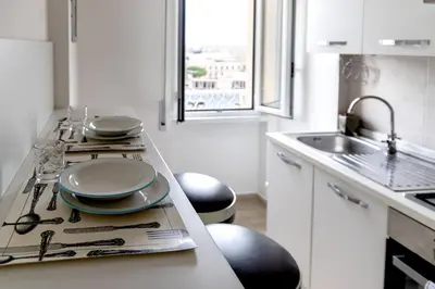 a kitchen with a counter top with dishes on it at Sapienza Apartment by RHR in Rome