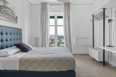 a bedroom with a large bed and a window at Sapienza Apartment by RHR in Rome