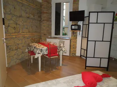 a dining room with a table and chairs in a room at A Casa Di Lucia in Rome