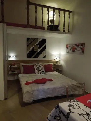 a bedroom with a bed with a red blanket on it at A Casa Di Lucia in Rome