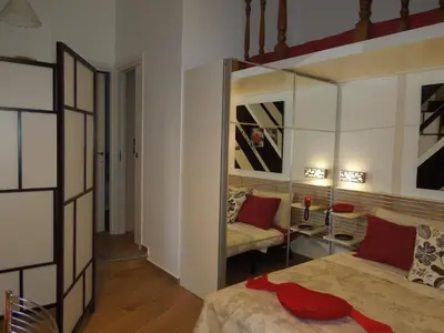 a bedroom with a mirror and a bed and a couch at A Casa Di Lucia in Rome