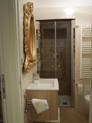 a bathroom with a sink and a shower with a mirror at A Casa Di Lucia in Rome