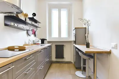 a kitchen with a counter and a sink and a window at Campo de' Fiori Brand New Apartment in Rome