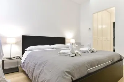 a bedroom with a large bed with towels on it at Campo de' Fiori Brand New Apartment in Rome