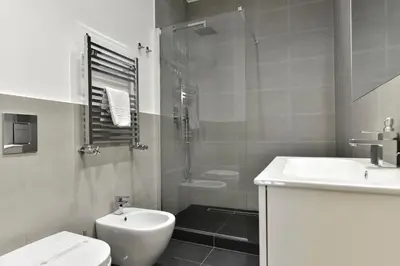 a bathroom with a sink and a toilet and a shower at Campo de' Fiori Brand New Apartment in Rome