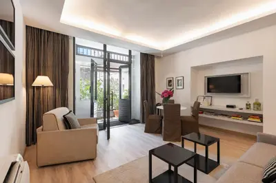 a living room with a couch and a tv at Margutta Mews in Rome