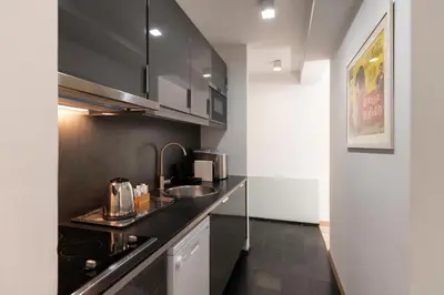 a kitchen with a sink and a counter top at Margutta Mews in Rome
