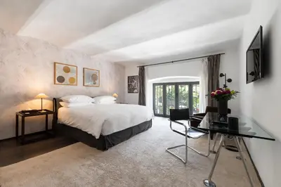 a bedroom with a bed and a desk and a window at Margutta Mews in Rome